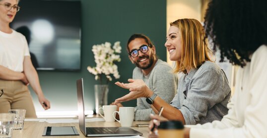 Cheerful businesswoman having a discussion with her colleagues