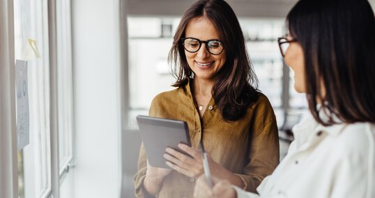 Business women standing in an office and discussing their ideas