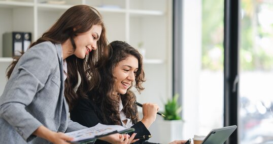 girl working together offer ideas to each other.happy young business colleagues working in the office